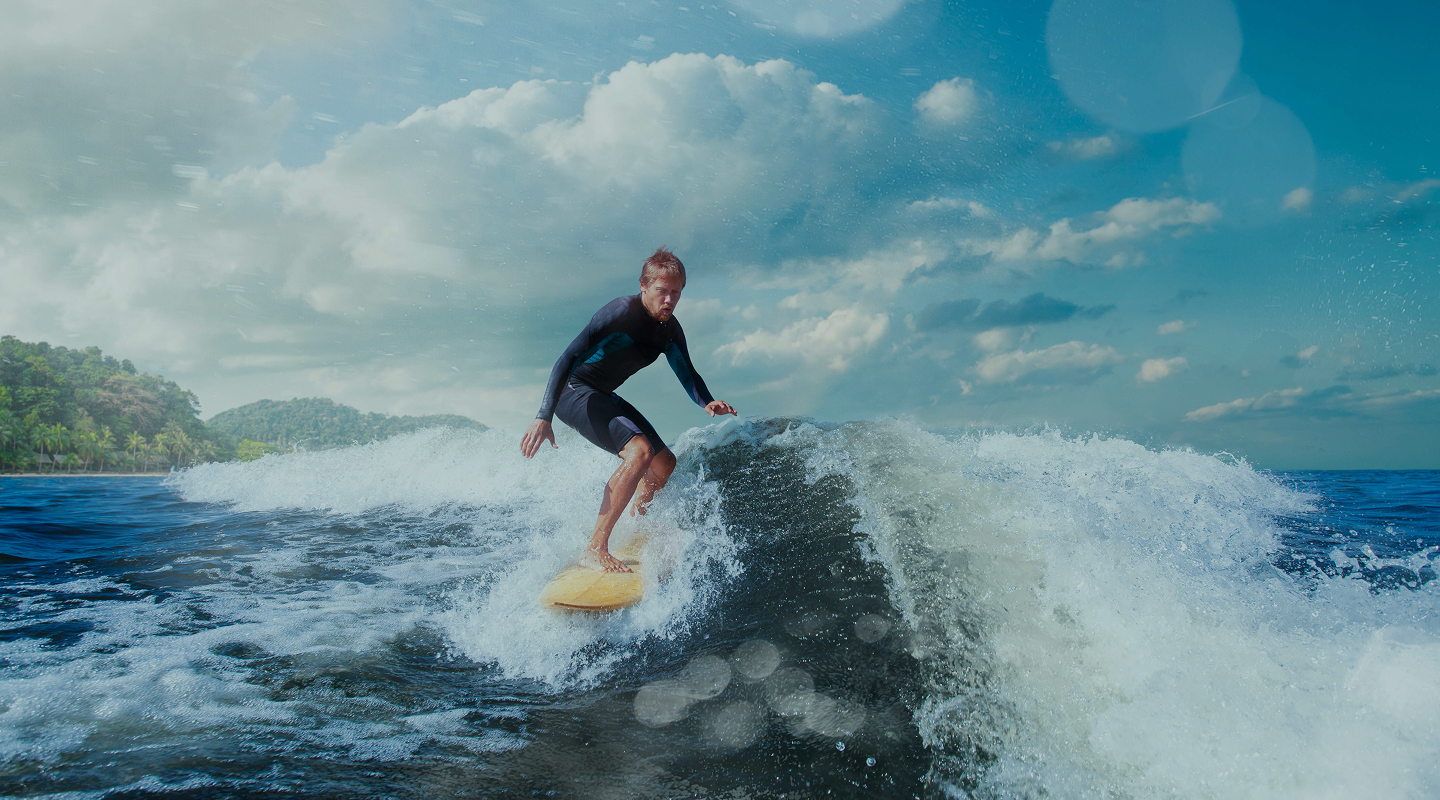 surfer-blue-ocean-wave-getting-barreled 1