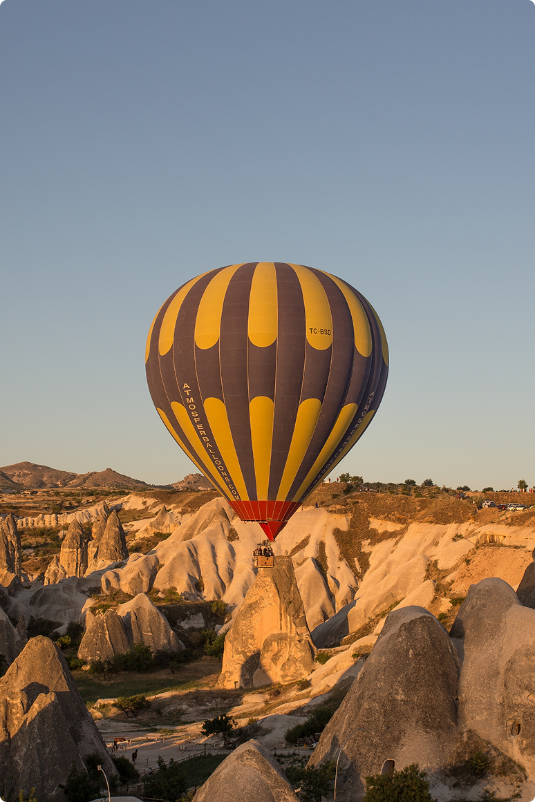 hot-air-balloons-hills-fields-sunset-cappadocia-turkey