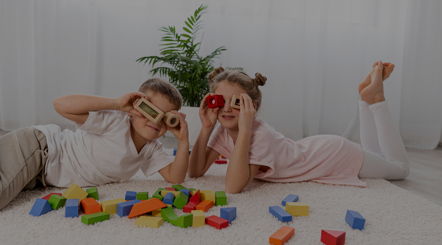 non-binary-kids-playing-with-colorful-game-home