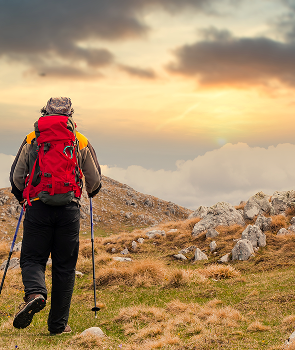 back-view-hiker-watching-sunset-from-mountain