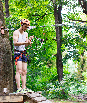 man-prepares-climb-ropes-park